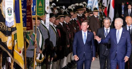 El Presidente de Estados Unidos, a la derecha, saluda mientras pasa junto a carabineros de montaña bávaros con ropas tradicionales a su llegada al aeropuerto de Francisco José cerca de Múnich, Alemania, el sábado 25 de junio de 2022, antes de una cumbre del G7.