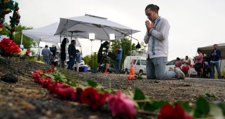 Carlow Eduardo Espina reza después de colocar rosas en un altar improvisado en el lugar en el que las autoridades encontraron a medio centenar de migrantes muertos dentro de un tractocamión, el martes 28 de junio de 2022, en San Antonio.